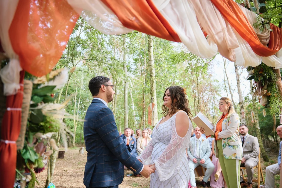Wedding guests gathered for a woodland ceremony
