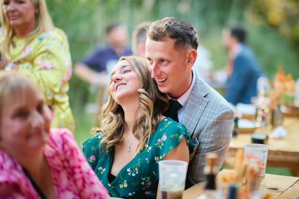 An affectionate moment between wedding guests
