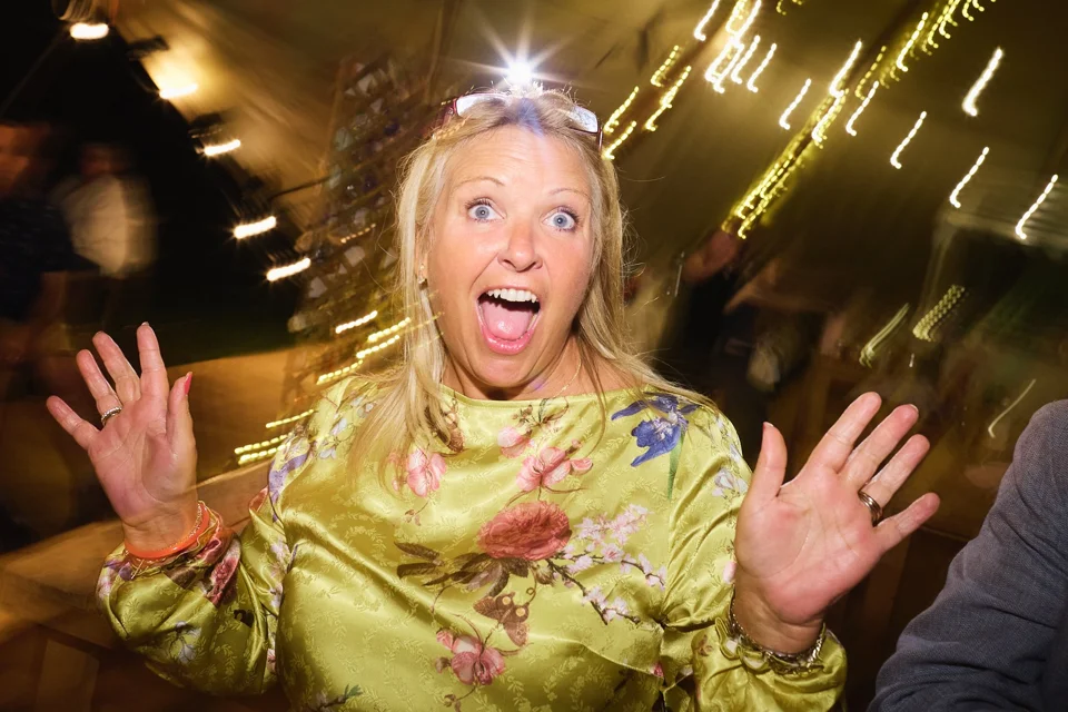 A dancing guest surrounded by coloured light trails