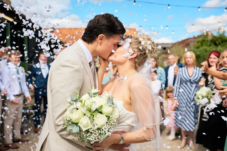 The newly married couple walking through confetti