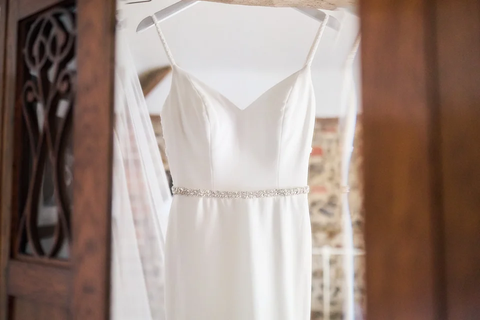 The wedding dress hanging before the day begins