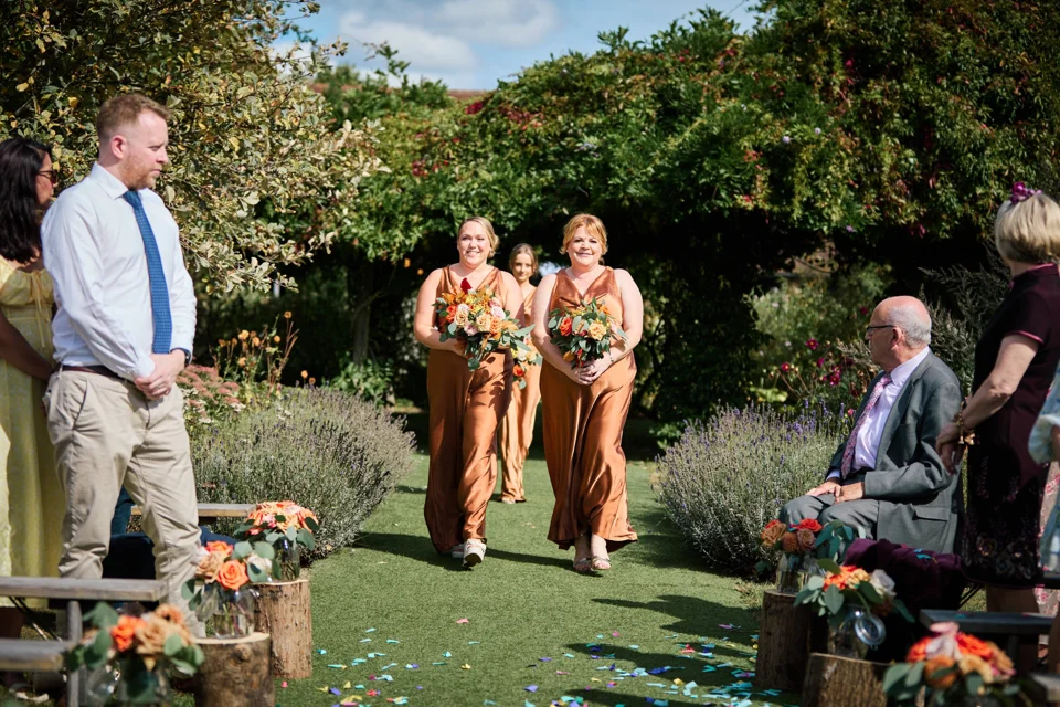 The wedding party entering the garden ceremony