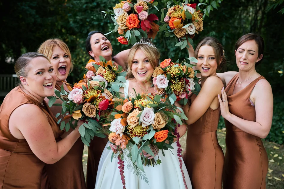 The bride and bridesmaids lifting their bouquets